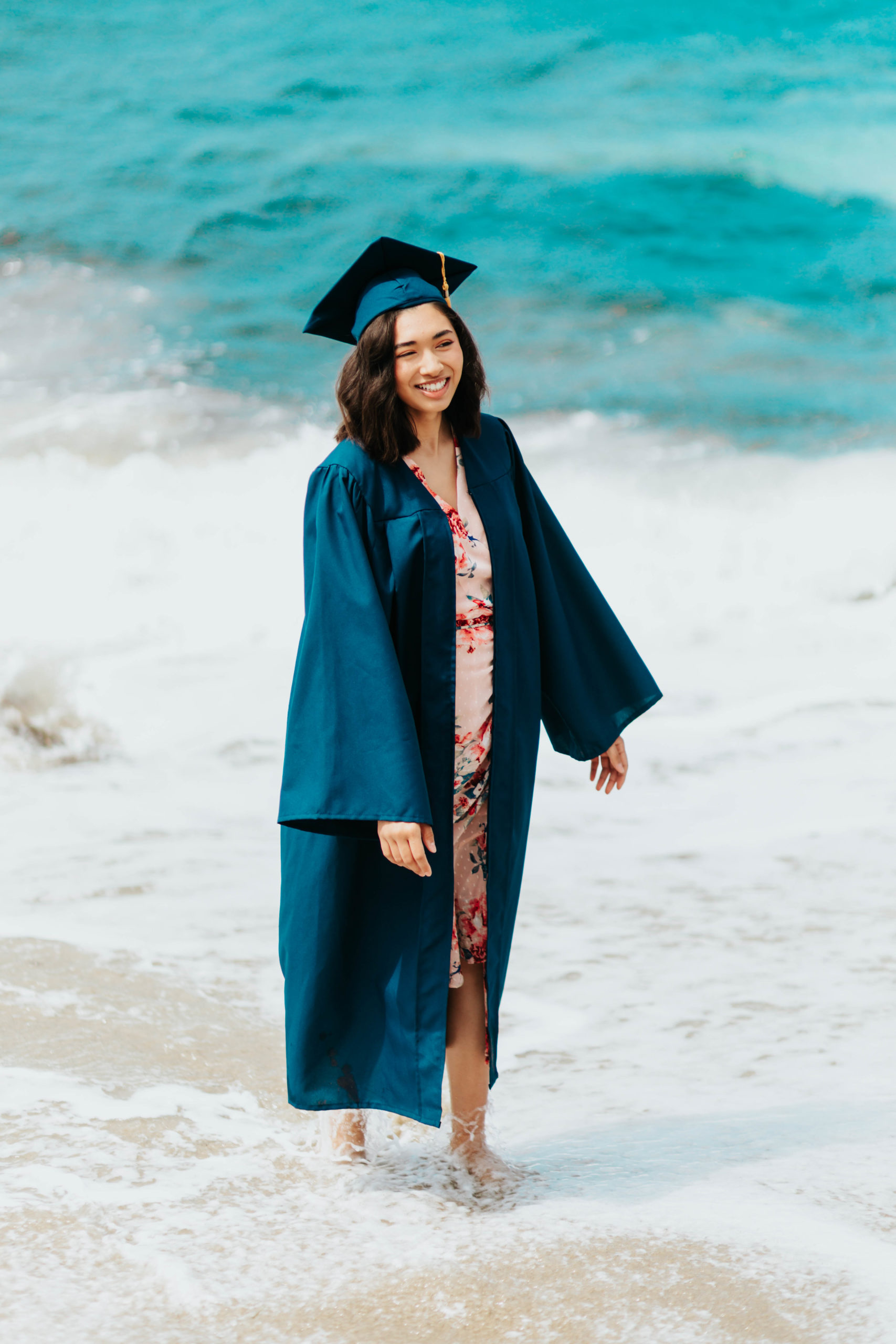 High school graduate walking on beach